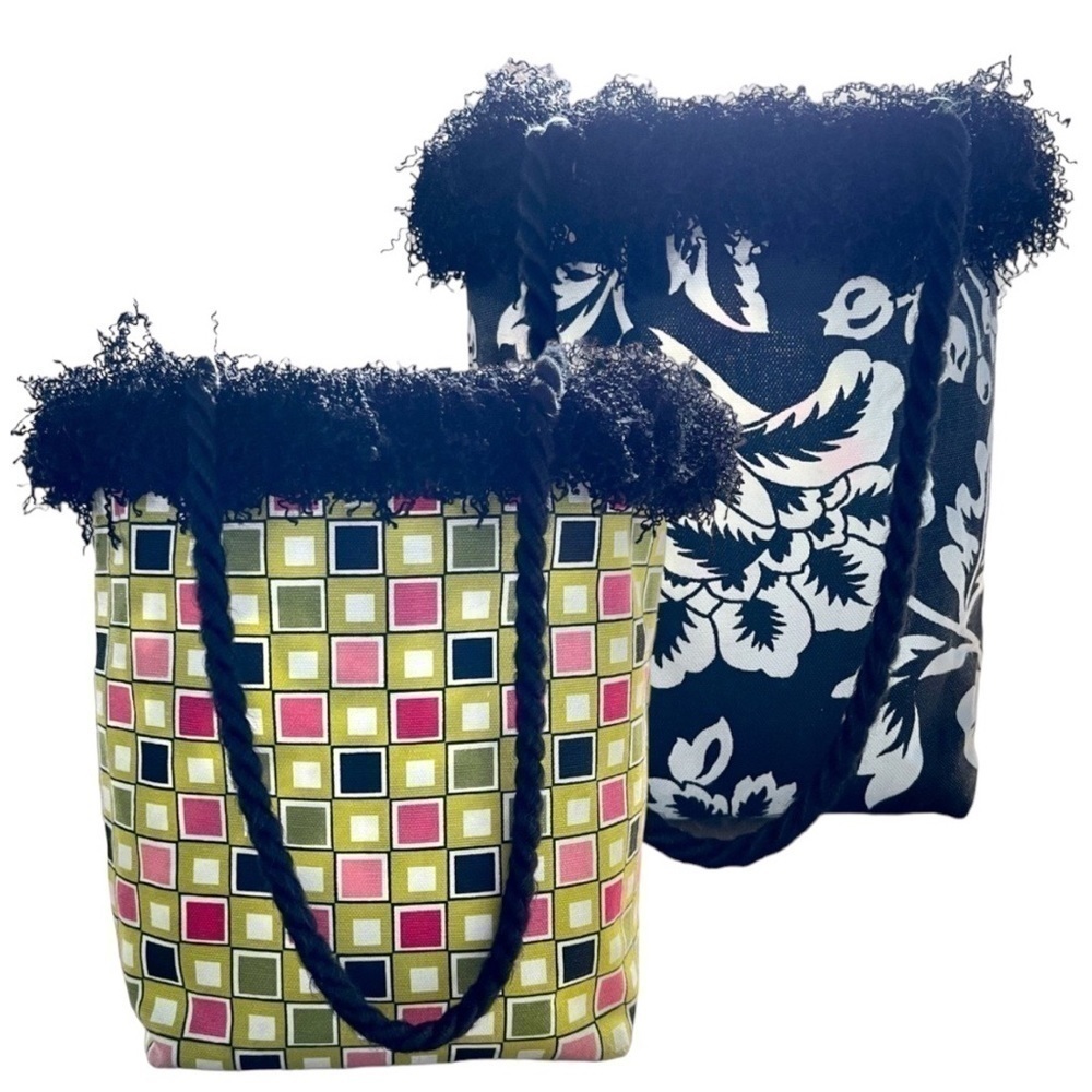 SMALL, REVERSIBLE, CANVAS PURSE. MEASURES AT BASE, 7”W X 4”D X 10”H. NO BRAND.